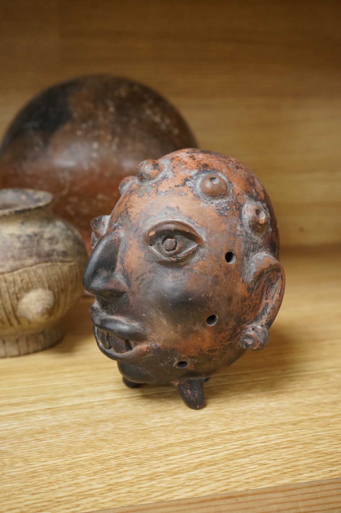 A collection of various South American vessels some in the form of grotesque heads, largest 24cm wide